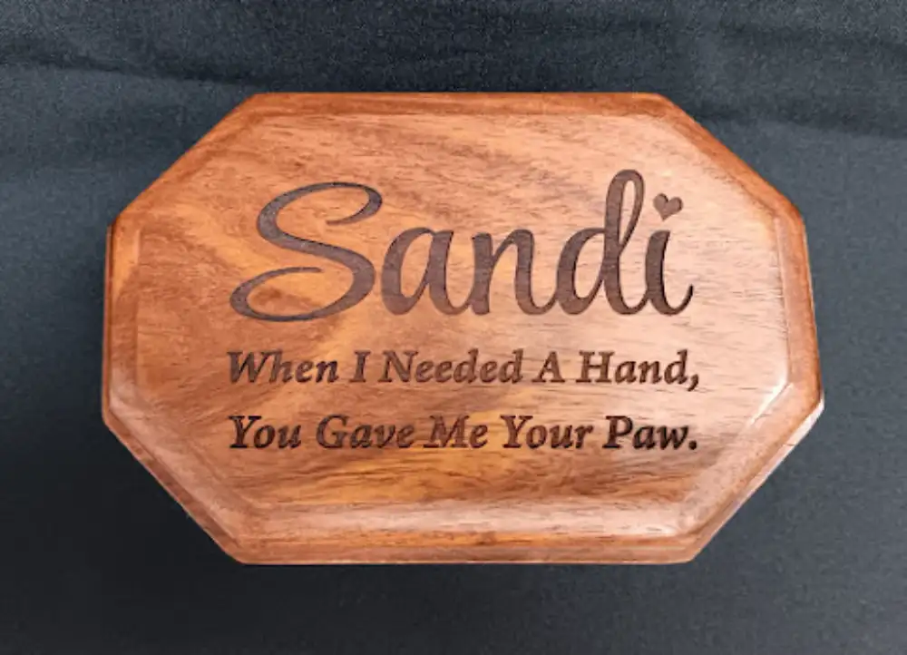Custom engraved wooden memorial box for Sandi with a heartfelt paw tribute