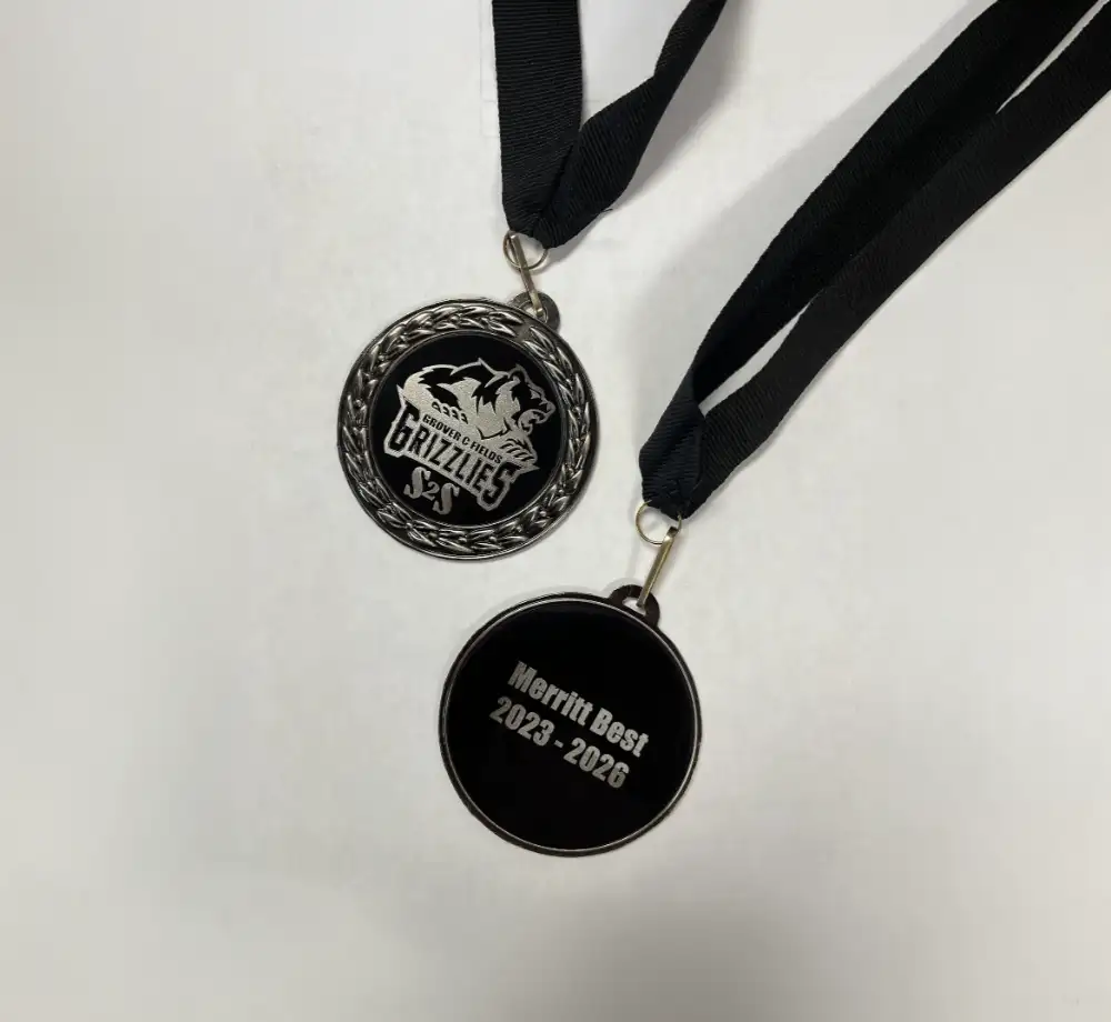 Custom engraved black medals featuring Grizzlies and Merritt Best 2023–2026 designs
