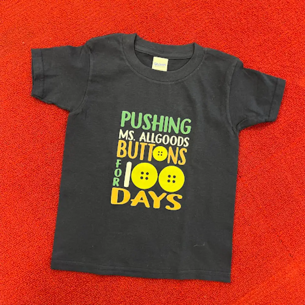 Custom screen printed black t-shirt with colorful text and button designs