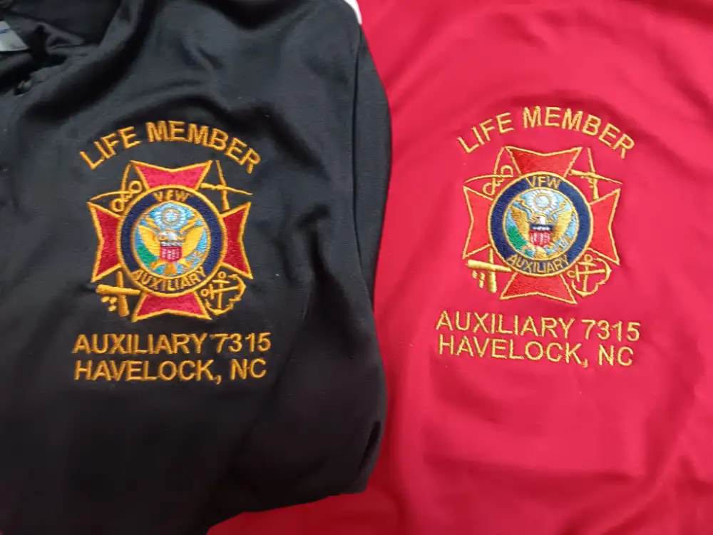 Custom embroidered red and black shirts with logos and lettering