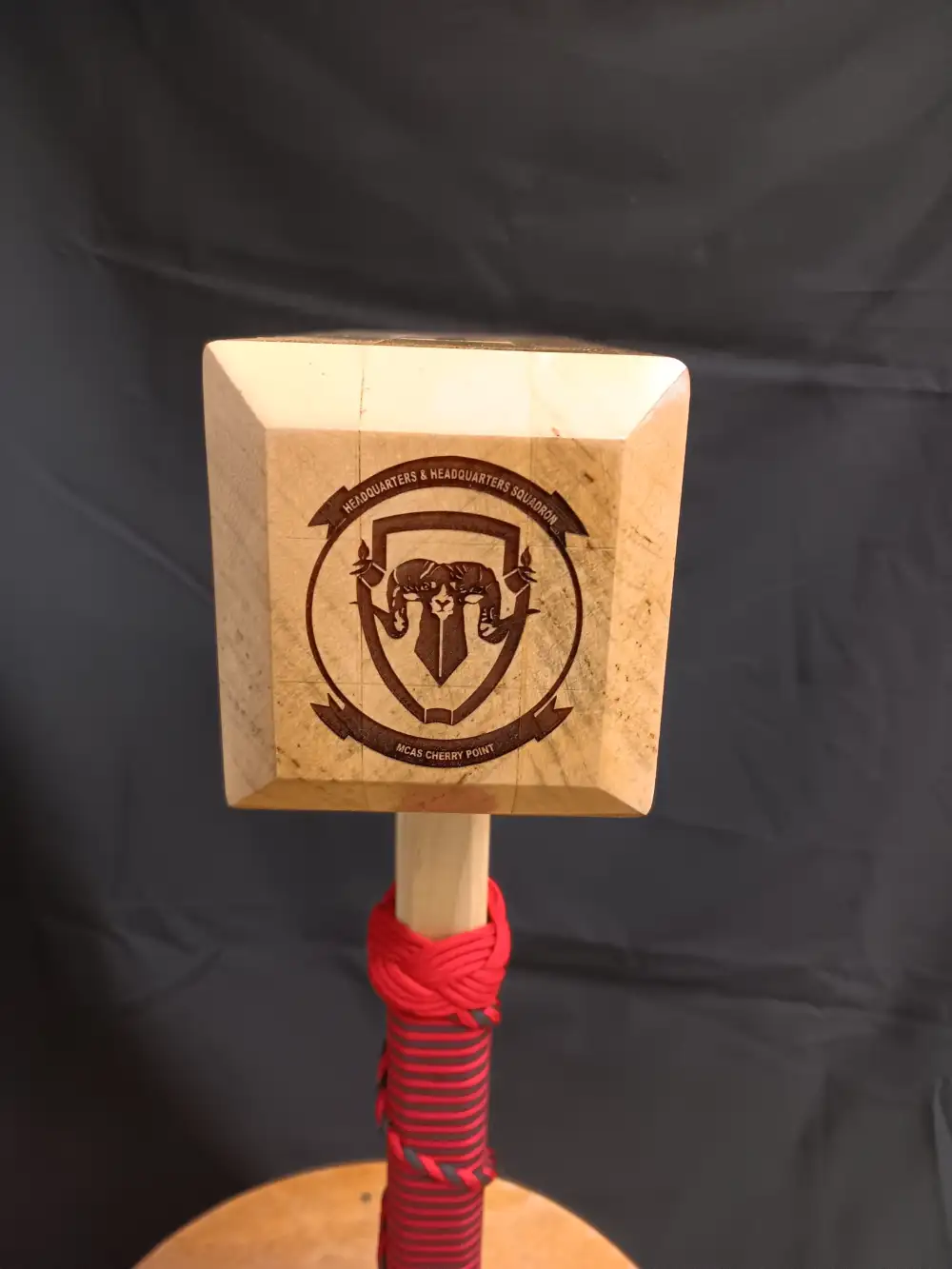 Custom engraved wooden paddle featuring a horned ram emblem and surrounding text